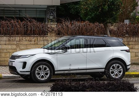 Side, Turkey - January  2023:  White Range Rover Evoque   Is Parked  On The Street On A Warm Summer 