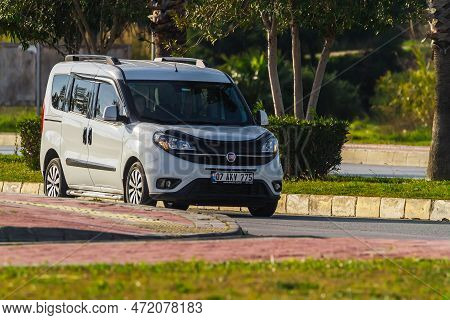 Side, Turkey -  January 31 2023:   White Fiat Doblo  Is Driving Fast On The Street On A Warm Summer 