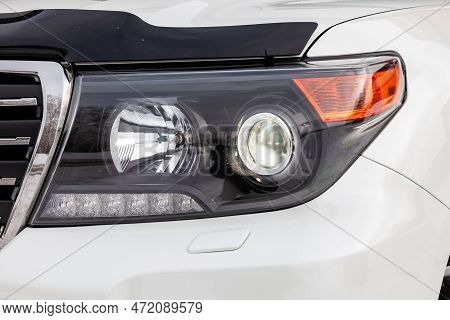 Novosibirsk, Russia - 04.03.2023: Headlight View Of Toyota Land Cruiser 200 J200 2013 Year White Col