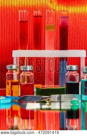 Collection Of Drug Vials On Red Background. Scientific Lab Medicine Reserarch.