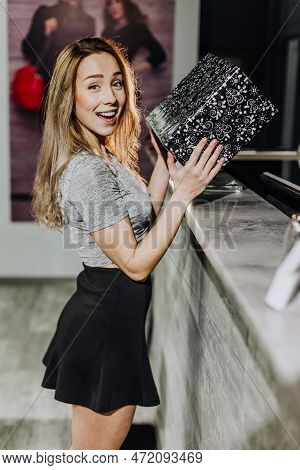 Woman With Dress In The Checkroom. A Clothing Store