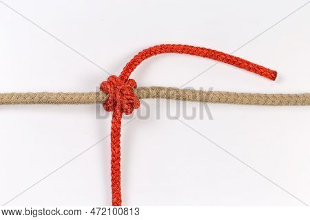 Tightened Rope Double Constrictor Knot Tied With An Accessory Cord Around The Thick Rope On A White 