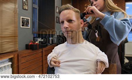 A Man With Disabilities Gets His Hair Cut And Styled In A Barber Shop.