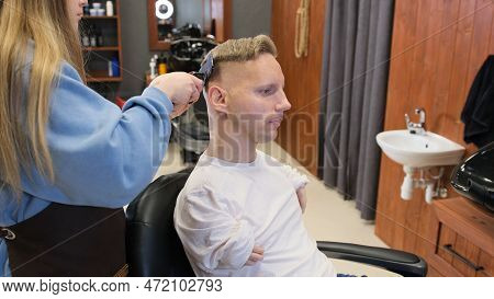 A Man With Disabilities Gets His Hair Cut And Styled In A Barber Shop.