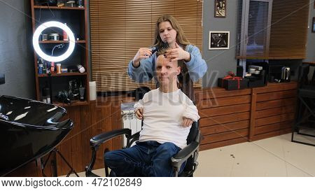 A Man With Disabilities Gets His Hair Cut And Styled In A Barber Shop.
