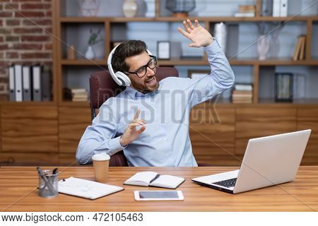 Mature Boss Investor At Workplace Inside Home Office Dancing Having Fun Listening To Music In Headph