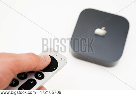 Man Hand Switches On The New Black Apple Tv 4k Media Streaming Using Remote Controller, February 202