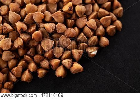 Buckwheat Groats On A Black Background. Macro. Close-up