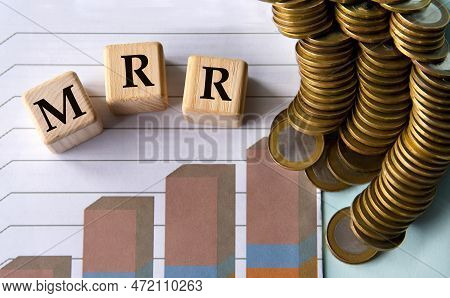 Mrr (monthly Recurring Revenue) - Abbreviation On Wooden Cubes On The Background Of Graph And Coins