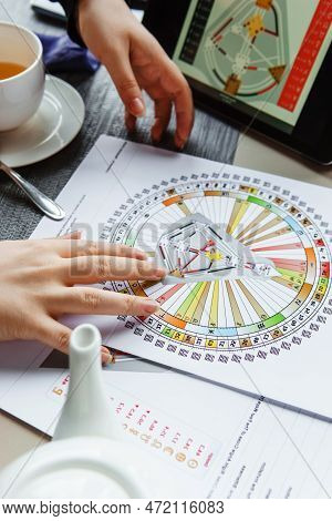 Tver, Russia - February 12, 2023: A Woman At The Table Is Studying A Rave Mandala By Human Design. R