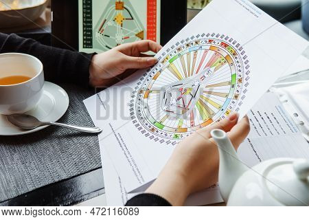 Tver, Russia - February 12, 2023: A Woman At The Table Is Studying A Rave Mandala By Human Design. R