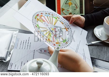 Tver, Russia - February 12, 2023: A Woman At The Table Is Studying A Rave Mandala By Human Design. R