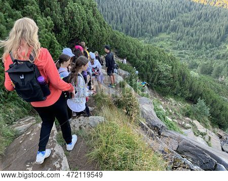 A Group Of Travelers In The Summer Against The Backdrop Of The Mountains. Youth Camp In The Carpathi