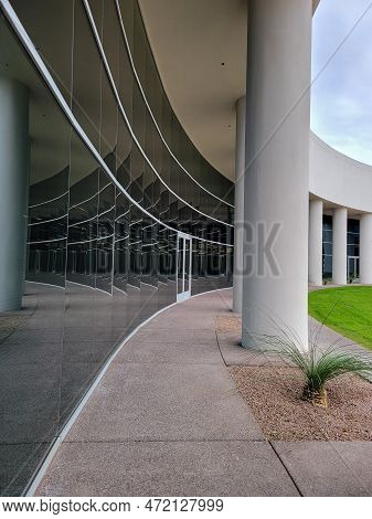Architecture Details Reflection In Black Mirrror-like Glass Wall Running Together With Support Colum