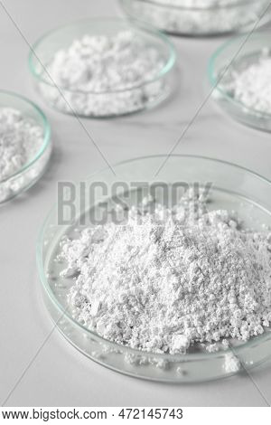 Many Petri Dishes With Calcium Carbonate Powder On White Table