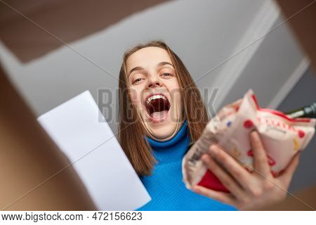 Amazed Extremely Happy Woman Looking Inside Box With Grocery, Making Online Shopping, Holding Packag