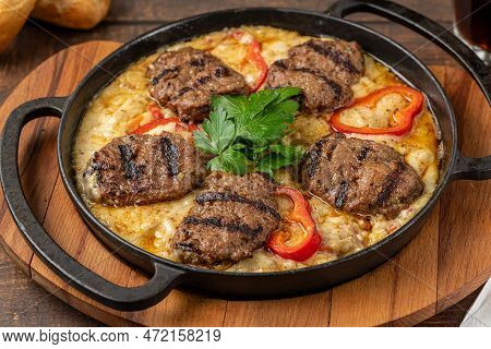 Meatballs With Alinazik Sauce. Traditional Turkish Meatballs On Eggplant Puree In Cast Iron Skillet