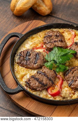 Meatballs With Alinazik Sauce. Traditional Turkish Meatballs On Eggplant Puree In Cast Iron Skillet