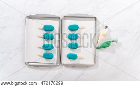 Flat Lay. Decorating Cakesicles With Drizzled Chocolate, Chocolate Mermaid Tails, And Seashells.