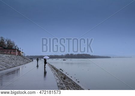 Belgrade, Serbia - January 31, 2016: Selective Blur On A Woman, Alone, With An Umbrella, Contemplati