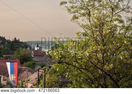 Panorama Of The Villae Of Stari Slankamen With Its Church And A Serbian Flag Over The Riverbank Of T