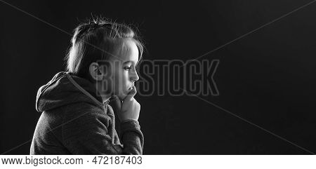 Sad Young Boy Thinking About His Problems. Afraid Child Sitting Quiet In Dark. Young Boy Suffering F