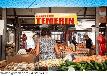 Novi Sad, Serbia - June 25, 2022: Selective Blur On An Old Merchant, Senior Woman, Selling Eggs In T