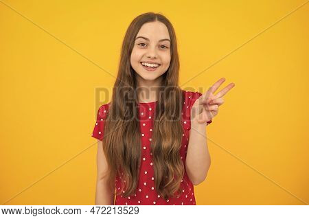 Cheaky Teen Girl Giving Victory Sign. Happy Teenager Child Smiling With V-sign, Positive Gesture, St