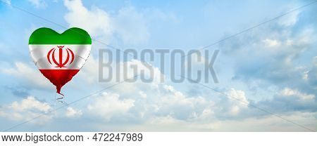Flag Of Iran On Heart-shaped Balloon Against Sky Clouds Background. Education, Charity, Emigration, 