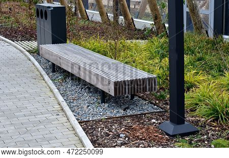 Perennial Bed Mulched With Gray Gravel In Front Of A Limestone Stone Wall In A Square With Benches W