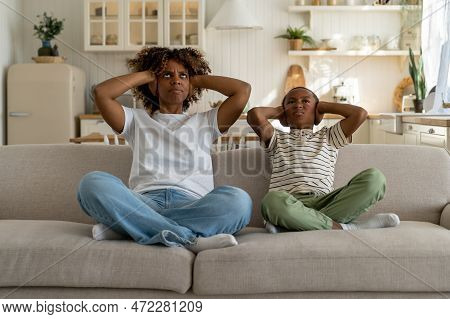 Dissatisfied Annoyed Stressed African American Woman Mom And Child Son Sitting On Crossed Legs, Disp