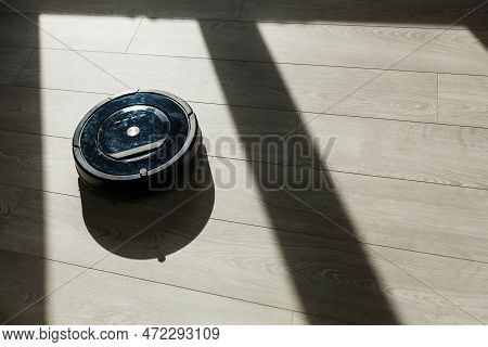 Robot Vacuum Cleaner On Laminate Wood Floor, Smart Robotic Wireless Technology Cleaning Machine In L