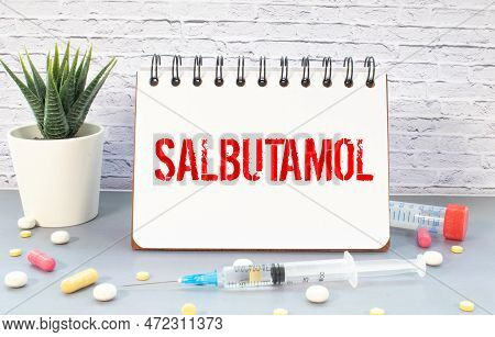 Word Asthma Written On A White Piece Of Paper. Pills And Vitamins Lie Nearby