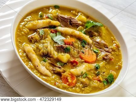 Gungo Peas, Pigeon Peas Soup With Dumplings , Vegetables And Beef In White Bowl