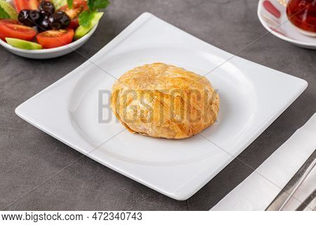 Izmir Boyoz On A White Porcelain Plate On A Stone Table
