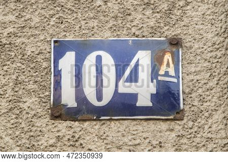 Weathered Grunge Square Metal Enameled Plate Of Number Of Street Address With Number 104