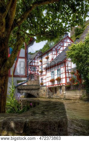 The River Elzbach Running Through The Village Of Monreal, Germany, With Its Beautiful Half-timbered 