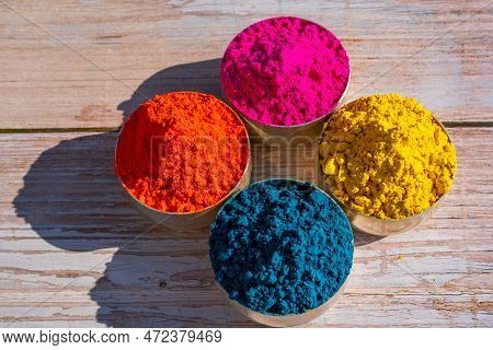 Colorful Powder Organic Gulal Colors In Bowls For Indian Holi Festival. Wooden Background. High Qual
