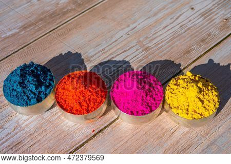 Colorful Powder Organic Gulal Colors In Bowls For Indian Holi Festival. Wooden Background. High Qual