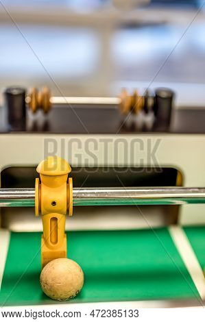 Selective Focus On A Foosball Goalie Blocking The Ball Insider The Box.