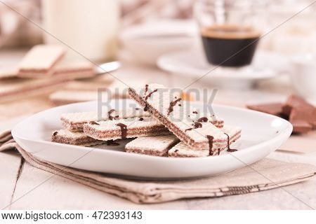 Neapolitan Wafers Filling With Hazelnut-chocolate Cream On White Dish.