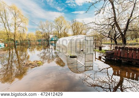 Vegetable Garden Beds In Water During Spring Flood Floodwaters During Natural Disaster. Greenhouse H