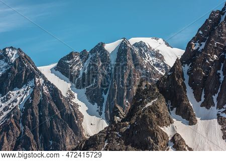 Scenic Alpine Landscape With Snowy Mountain Peak In Sunny Day. Awesome Landscape With Rocky Pinnacle