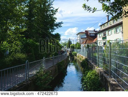 Water Canal Seen In The City Of Oberkirch In Baden-wurttemberg With Houses On One Side And Park On A