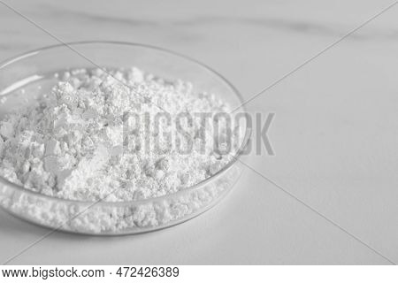 Petri Dish With Calcium Carbonate Powder On White Marble Table, Closeup. Space For Text