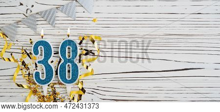 Number 38 Blue Celebration Candle On White Wooden Background. Happy Birthday Candles. Concept Of Cel