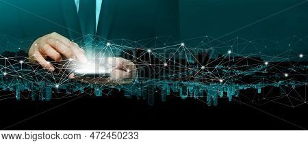 Business Person In Siut Hand Holding Smart Phone With Light Screen On Background Of City. Communicat