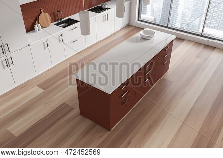 Top View Of White Home Kitchen Interior With Bar Island, Kitchenware On Deck And Hardwood Floor. Sty