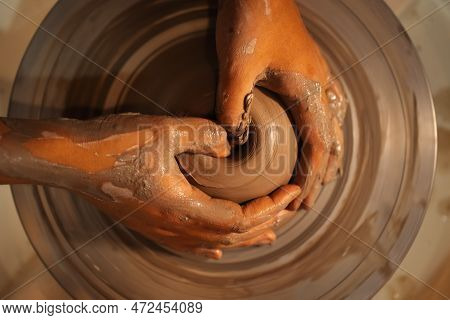 Close Up On Skillful Hands Sculpting Pottery Jar On Potter Wheel