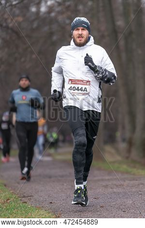 Ostrava, Czechia - 02.04.2023: Vertical Shot Of Male Runners In Sportswear Competing During Winter A